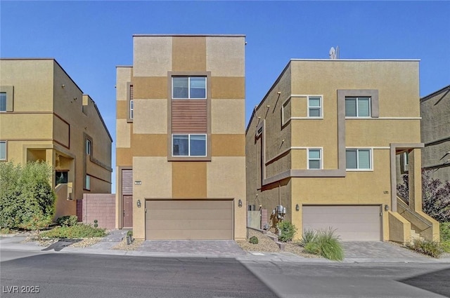 3908 Total Eclipse St, Las Vegas, NV 89129 - view of front of property featuring an attached garage, stucco siding, and decorative driveway