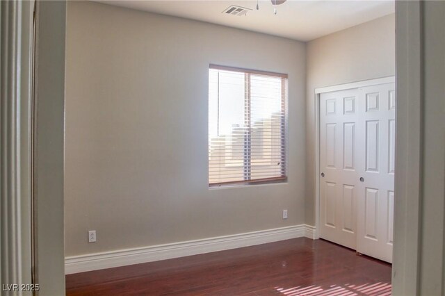 72 Broken Putter Way, Las Vegas, NV 89148 - unfurnished bedroom featuring dark wood finished floors and a closet