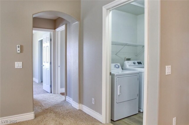 72 Broken Putter Way, Las Vegas, NV 89148 - washroom featuring arched walkways, separate washer and dryer, and light colored carpet