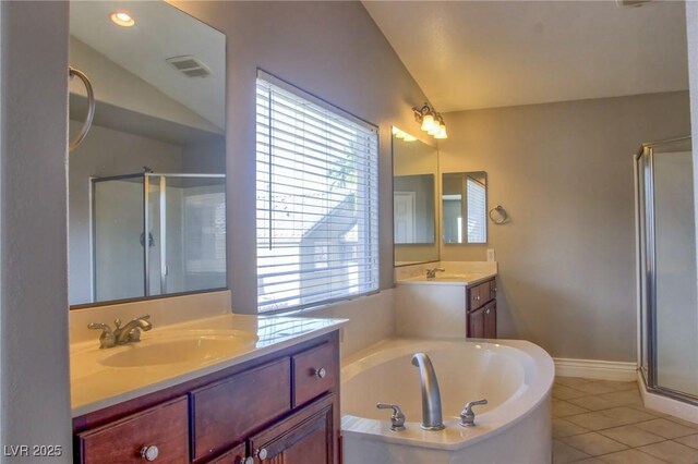 72 Broken Putter Way, Las Vegas, NV 89148 - bathroom with lofted ceiling, a stall shower, two vanities, a bath, and tile patterned floors
