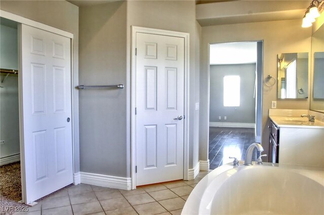 72 Broken Putter Way, Las Vegas, NV 89148 - bathroom with vanity, a garden tub, and tile patterned flooring