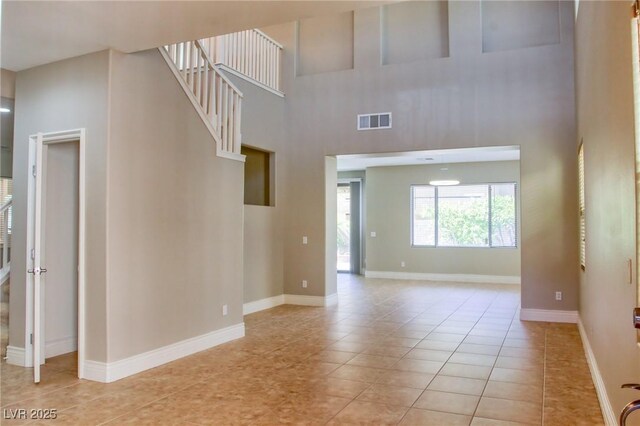 72 Broken Putter Way, Las Vegas, NV 89148 - empty room with light tile patterned floors and a towering ceiling