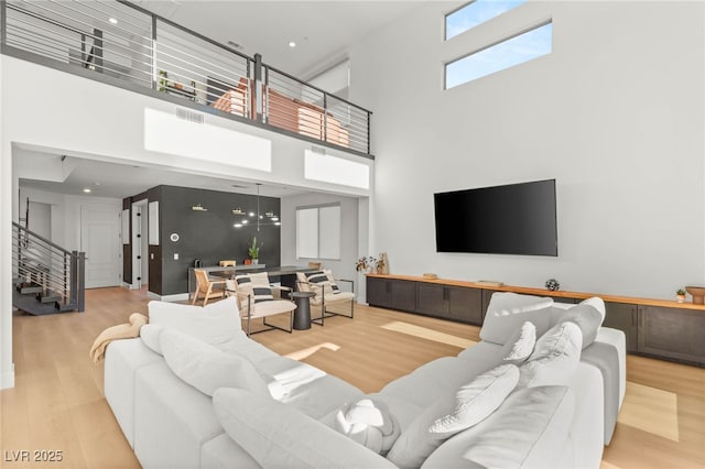 389 Red Feather Peak Ct, Las Vegas, NV 89138 - living area with stairway, a towering ceiling, and wood finished floors