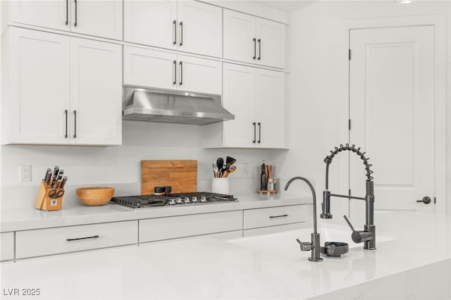 389 Red Feather Peak Ct, Las Vegas, NV 89138 - kitchen with ventilation hood, stainless steel gas stovetop, and white cabinetry