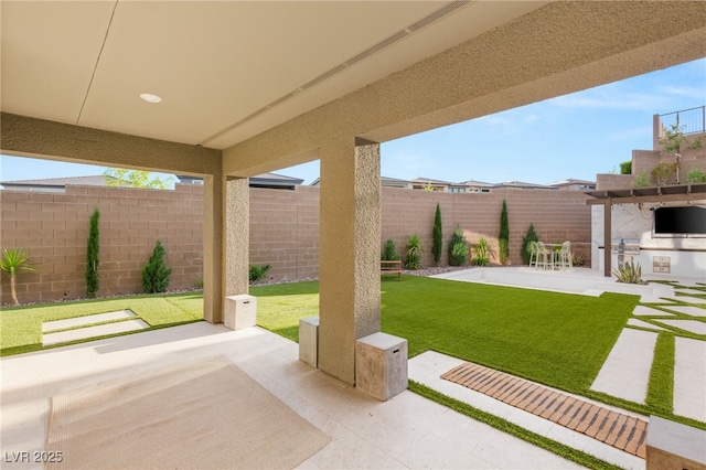 389 Red Feather Peak Ct, Las Vegas, NV 89138 - fenced backyard with a patio and an outdoor kitchen