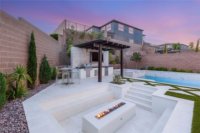 389 Red Feather Peak Ct, Las Vegas, NV 89138 - fenced backyard with an outdoor kitchen, a fire pit, a patio, a pergola, and a pool with connected hot tub