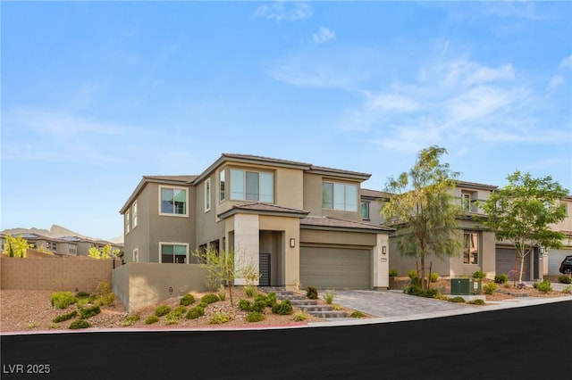 389 Red Feather Peak Ct, Las Vegas, NV 89138 - prairie-style home featuring stucco siding, driveway, a garage, and a residential view