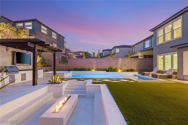 389 Red Feather Peak Ct, Las Vegas, NV 89138 - fenced backyard with an outdoor fire pit, an outdoor kitchen, a patio area, and a pool with connected hot tub