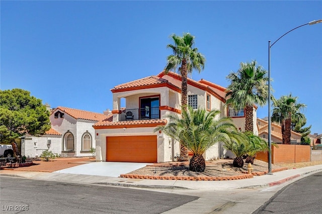 6652 Coral Springs Cir, Las Vegas, NV 89108 - mediterranean / spanish-style house featuring a balcony, stucco siding, a tiled roof, a garage, and concrete driveway
