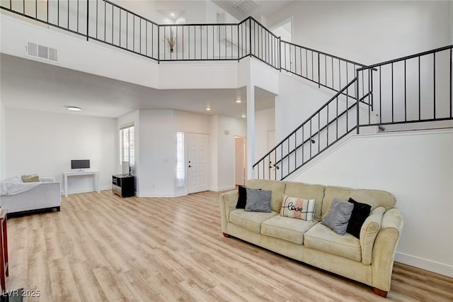 6652 Coral Springs Cir, Las Vegas, NV 89108 - living area with a towering ceiling, stairs, and wood finished floors