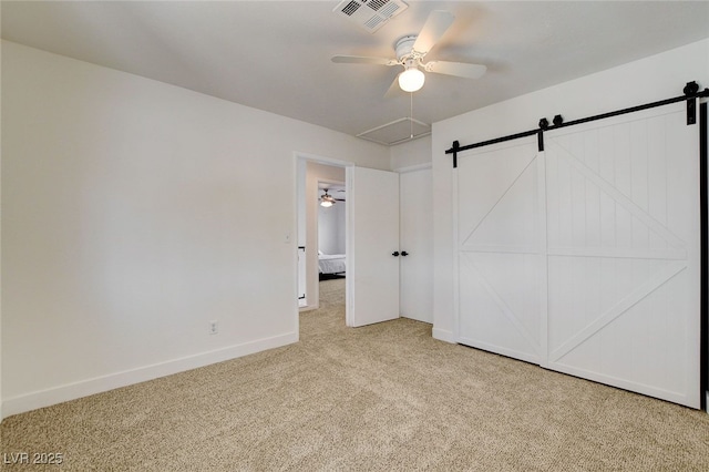 6652 Coral Springs Cir, Las Vegas, NV 89108 - unfurnished bedroom with light colored carpet, a barn door, and a ceiling fan