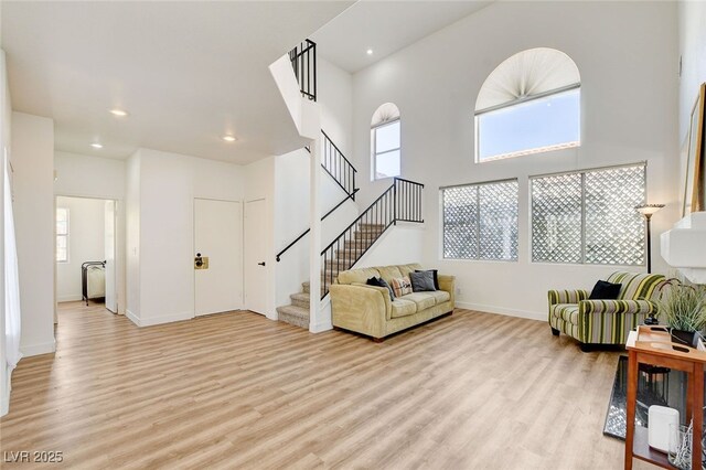 6652 Coral Springs Cir, Las Vegas, NV 89108 - living room featuring light wood finished floors, stairway, healthy amount of natural light, and recessed lighting