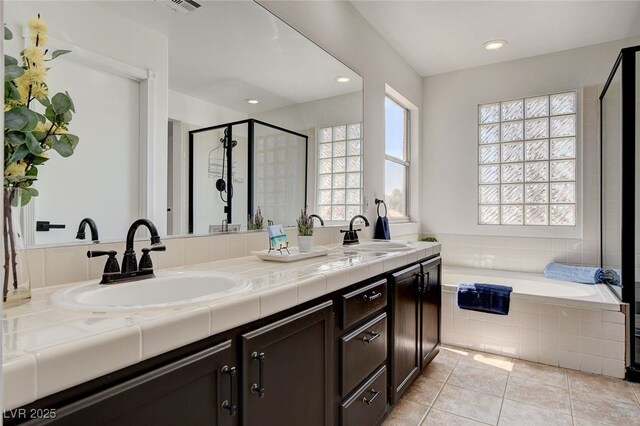 6652 Coral Springs Cir, Las Vegas, NV 89108 - bathroom featuring a garden tub, a shower stall, double vanity, tile patterned flooring, and recessed lighting