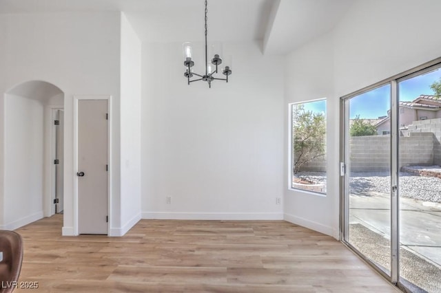 6456 First View Ave, Las Vegas, NV 89142 - unfurnished dining area featuring arched walkways, a chandelier, and light wood-style floors