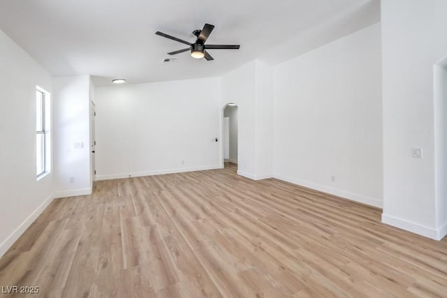 6456 First View Ave, Las Vegas, NV 89142 - spare room featuring light wood-style flooring, arched walkways, and ceiling fan