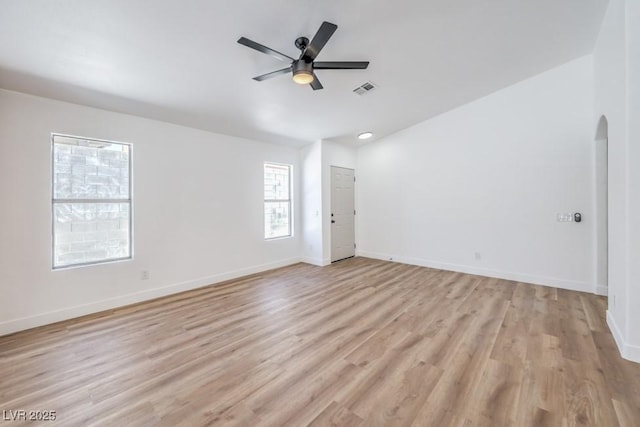 6456 First View Ave, Las Vegas, NV 89142 - spare room featuring ceiling fan, arched walkways, and light wood-style floors