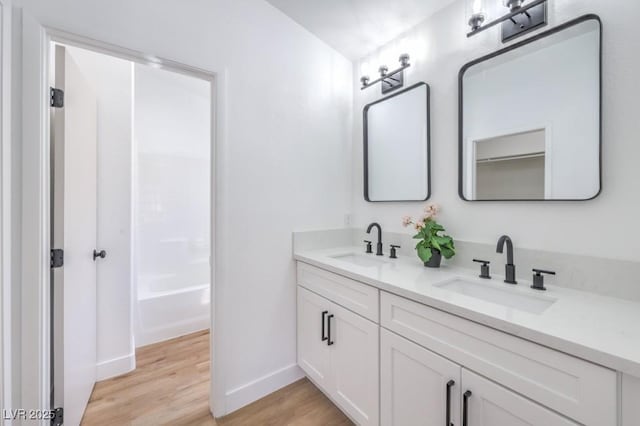 6456 First View Ave, Las Vegas, NV 89142 - bathroom with wood finished floors, double vanity, and tub / shower combination