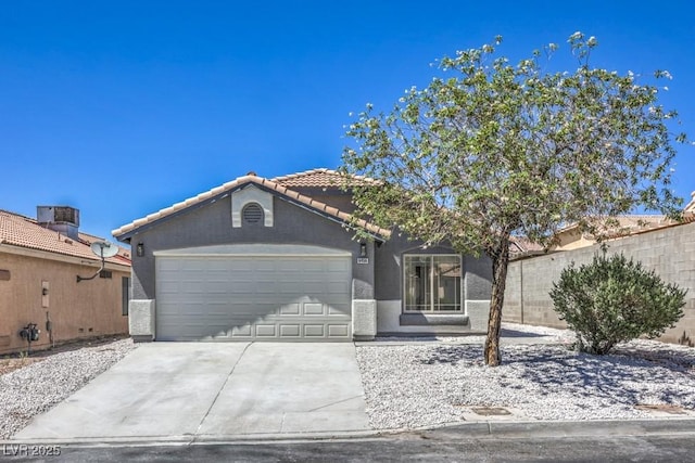 6456 First View Ave, Las Vegas, NV 89142 - view of front of property featuring an attached garage, driveway, stucco siding, and a tiled roof