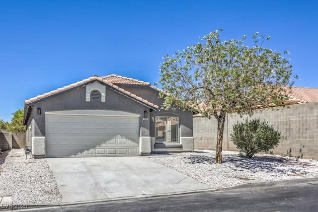 6456 First View Ave, Las Vegas, NV 89142 - view of front of house featuring a tile roof, an attached garage, driveway, and stucco siding