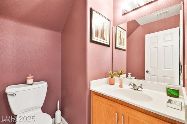 262 Cielito Lindo St, Henderson, NV 89012 - half bath with vanity, vaulted ceiling, and a textured wall