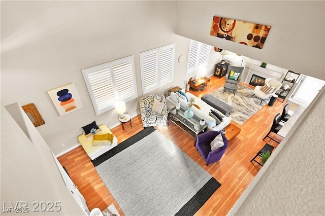 262 Cielito Lindo St, Henderson, NV 89012 - living area with wood finished floors and a glass covered fireplace