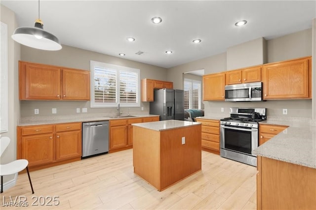 262 Cielito Lindo St, Henderson, NV 89012 - kitchen featuring stainless steel appliances, light stone counters, light wood finished floors, a kitchen island, and recessed lighting