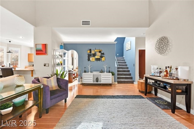 262 Cielito Lindo St, Henderson, NV 89012 - living room with wood finished floors, stairway, and arched walkways
