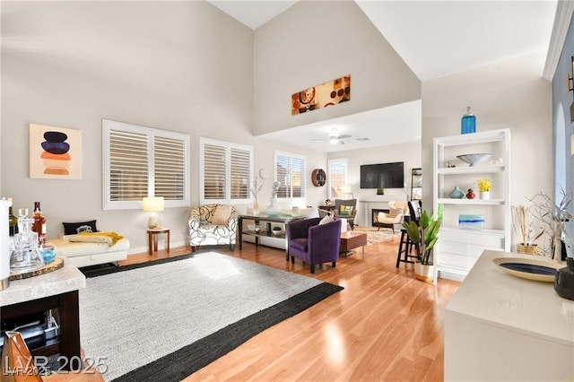 262 Cielito Lindo St, Henderson, NV 89012 - living room featuring light wood-style floors, a towering ceiling, and a ceiling fan