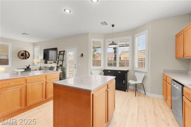 262 Cielito Lindo St, Henderson, NV 89012 - kitchen with stainless steel dishwasher, light wood-type flooring, a center island, light stone countertops, and recessed lighting