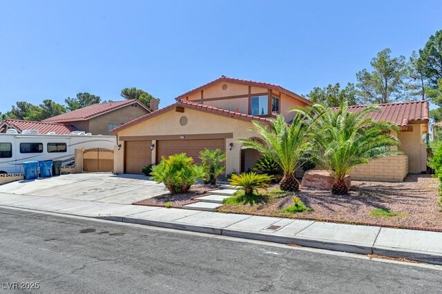 8729 Pesaro Dr, Las Vegas, NV 89117 - mediterranean / spanish-style house with stucco siding, a garage, concrete driveway, and a tiled roof