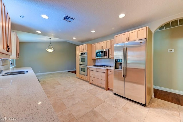 8729 Pesaro Dr, Las Vegas, NV 89117 - kitchen featuring stainless steel appliances, light brown cabinetry, recessed lighting, light stone countertops, and a textured ceiling