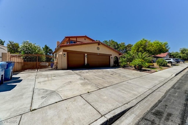 8729 Pesaro Dr, Las Vegas, NV 89117 - view of side of home with stucco siding, driveway, a garage, and a gate