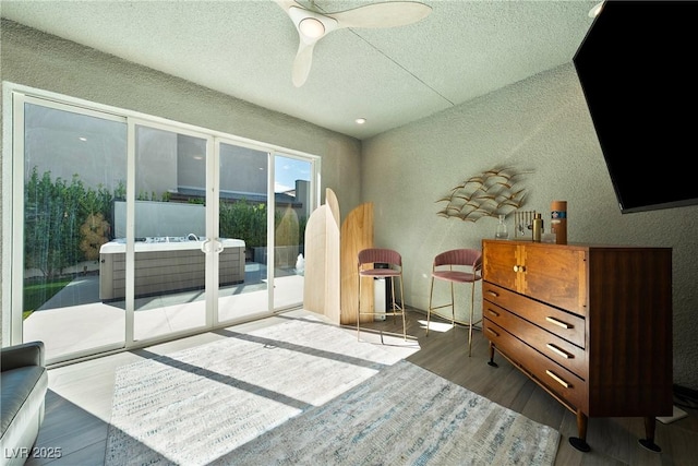 2722 Marchetti Pl, Henderson, NV 89044 - living area with a textured wall, wood finished floors, a textured ceiling, and a ceiling fan