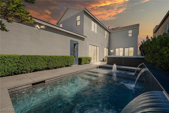 2722 Marchetti Pl, Henderson, NV 89044 - rear view of house featuring a hot tub, a patio area, stucco siding, and an outdoor pool