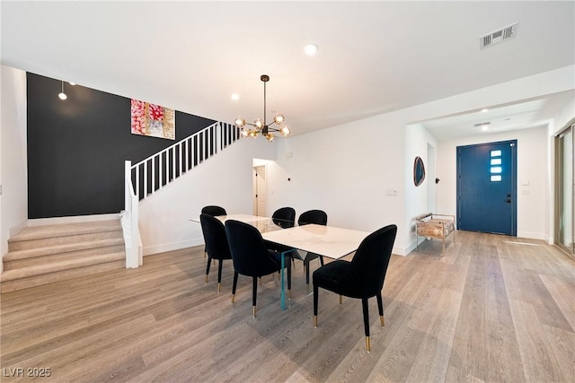 2722 Marchetti Pl, Henderson, NV 89044 - dining space with stairway, light wood-style floors, a chandelier, and recessed lighting