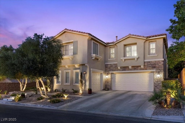 364 Trentino Alto St, Henderson, NV 89012 - mediterranean / spanish-style house with stone siding, an attached garage, concrete driveway, and stucco siding