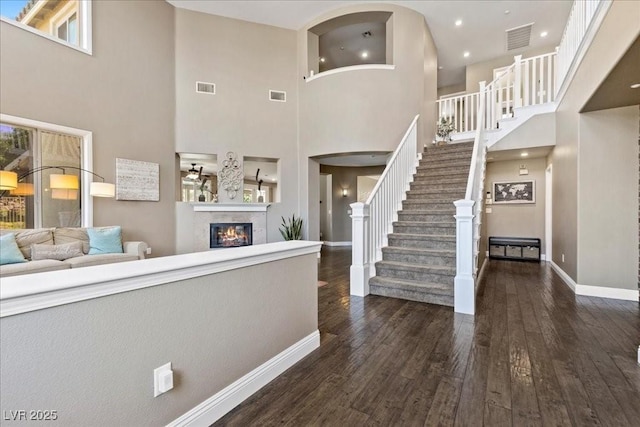 364 Trentino Alto St, Henderson, NV 89012 - foyer entrance with a towering ceiling, dark wood-type flooring, stairs, a glass covered fireplace, and recessed lighting