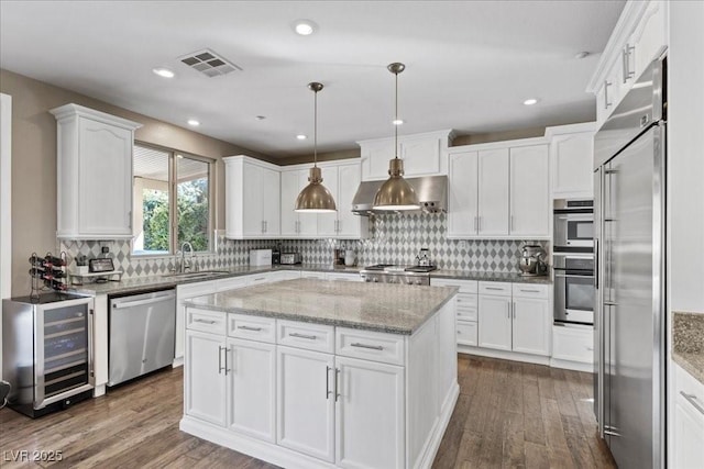364 Trentino Alto St, Henderson, NV 89012 - kitchen featuring stainless steel appliances, beverage cooler, white cabinets, dark wood-style floors, and a center island
