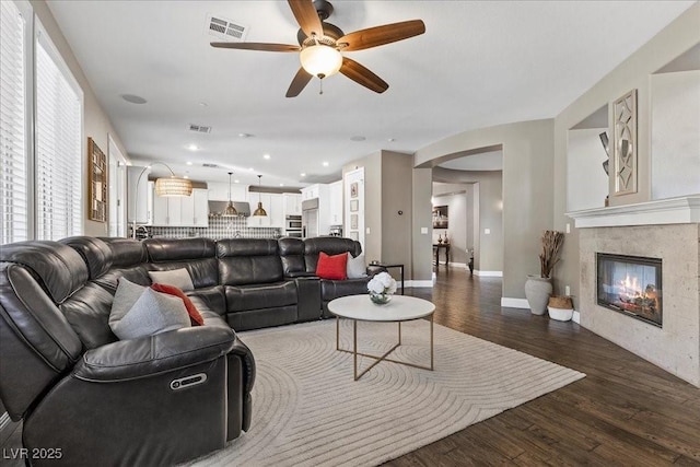364 Trentino Alto St, Henderson, NV 89012 - living room featuring ceiling fan, wood finished floors, arched walkways, a tile fireplace, and recessed lighting