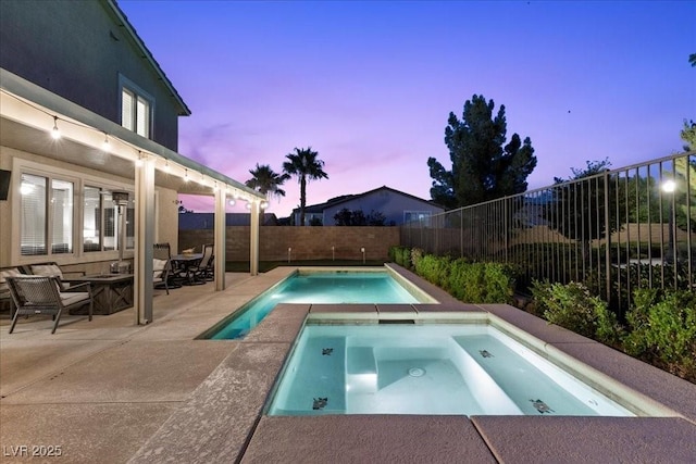 364 Trentino Alto St, Henderson, NV 89012 - pool at dusk with an in-ground hot tub, a patio area, and a fenced backyard