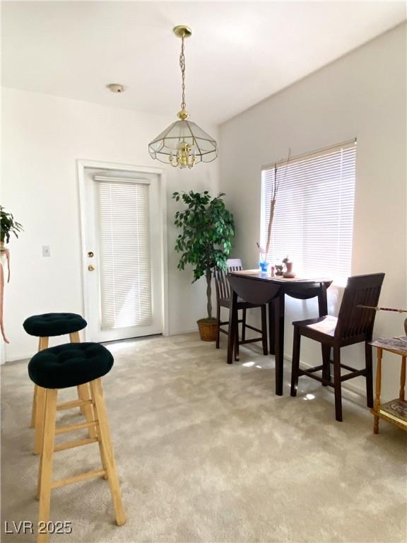 9470 Peace Way Unit 212, Las Vegas, NV 89147 - dining space with light colored carpet and a chandelier