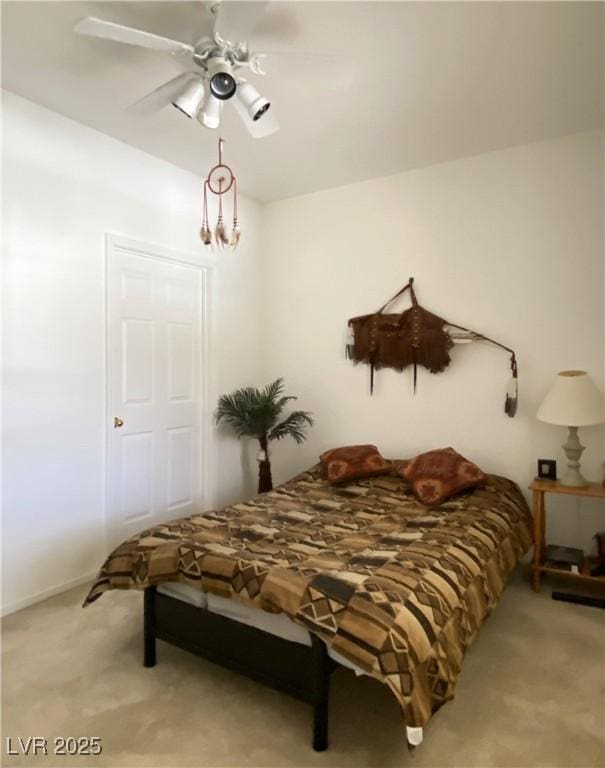 9470 Peace Way Unit 212, Las Vegas, NV 89147 - bedroom featuring light colored carpet, a chandelier, and ceiling fan