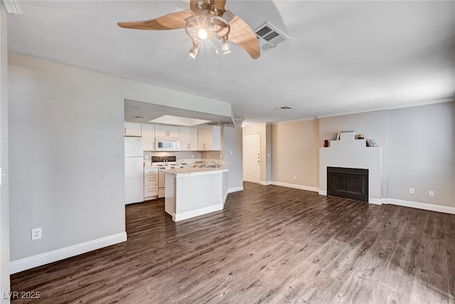8600 W Charleston Blvd Unit 1059, Las Vegas, NV 89117 - unfurnished living room featuring ceiling fan, dark wood-type flooring, a fireplace, and ornamental molding