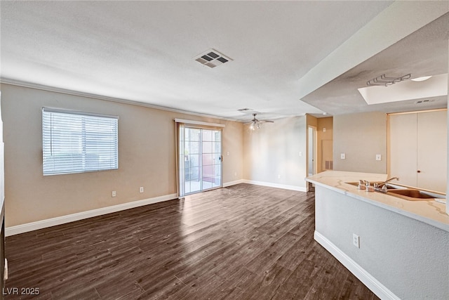 8600 W Charleston Blvd Unit 1059, Las Vegas, NV 89117 - unfurnished living room featuring dark wood-style floors and ceiling fan