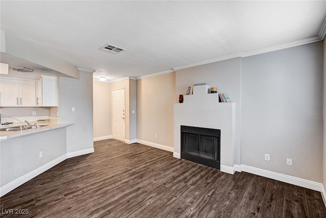 8600 W Charleston Blvd Unit 1059, Las Vegas, NV 89117 - unfurnished living room with dark wood-style flooring, a fireplace, and ornamental molding