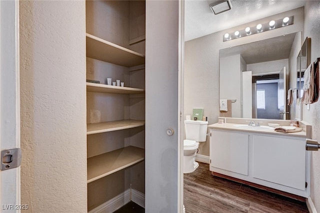 8600 W Charleston Blvd Unit 1059, Las Vegas, NV 89117 - bathroom with wood finished floors, vanity, and a textured wall