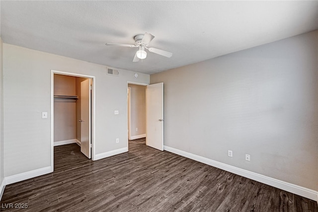 8600 W Charleston Blvd Unit 1059, Las Vegas, NV 89117 - unfurnished bedroom featuring dark wood-style floors, a closet, ceiling fan, and a walk in closet