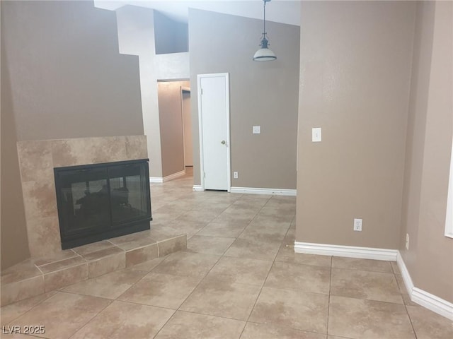 3116 Gentle Breeze St, Las Vegas, NV 89108 - unfurnished living room with a towering ceiling, light tile patterned flooring, and a tiled fireplace