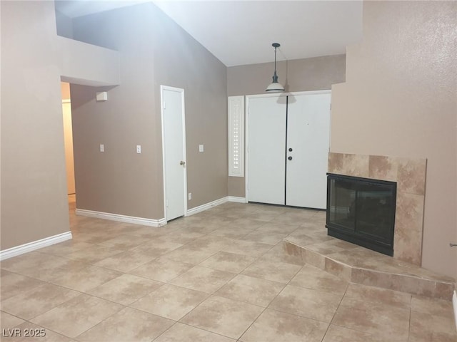 3116 Gentle Breeze St, Las Vegas, NV 89108 - unfurnished living room with a towering ceiling, light tile patterned flooring, and a tile fireplace