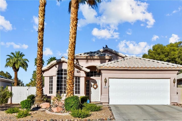 2512 Huber Heights Dr, Las Vegas, NV 89128 - view of front facade with an attached garage, concrete driveway, a tiled roof, and stucco siding